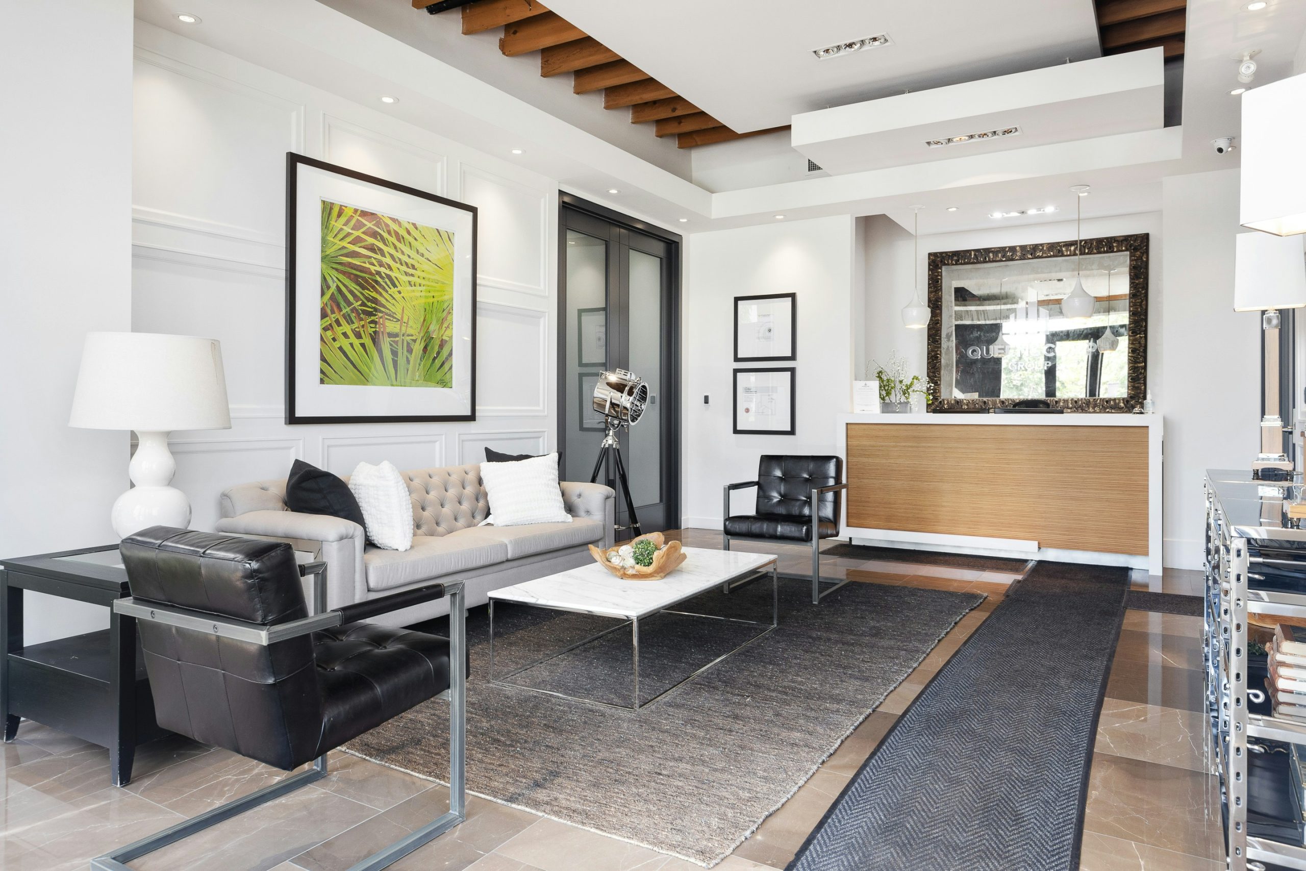 Stylish living room with gray sofa and framed wall art